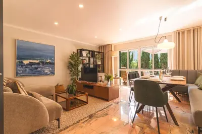 a living room with a table and a dining room at Costa Azul by Atlantic Holiday in Funchal