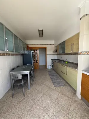 a large kitchen with a table and chairs in it at Barreiros View Vacations in Funchal
