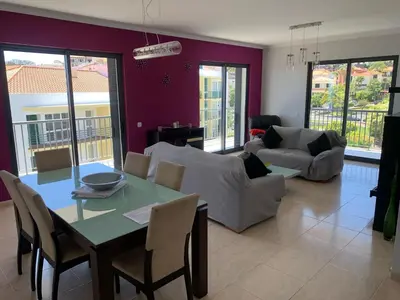 a living room with a table and chairs at Barreiros View Vacations in Funchal