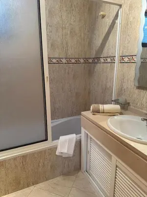 a bathroom with a sink and a tub at Barreiros View Vacations in Funchal