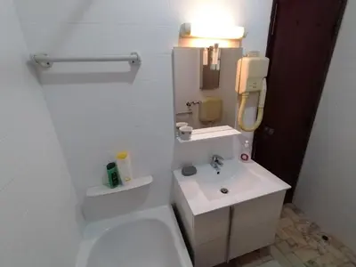 a white bathroom with a sink and a toilet at Casa Francis in Aljezur