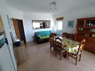 a living room with a table and chairs and a couch at Casa Francis in Aljezur