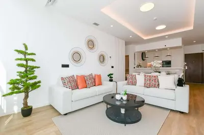 a living room with a white couch and a table at Cantinho do Atlântico in Funchal