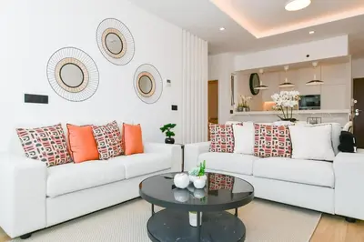 a living room with two white couches and a table at Cantinho do Atlântico in Funchal