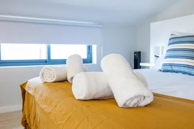 a room with a bed with towels on it at Palm Breeze Loft in Estreito da Calheta