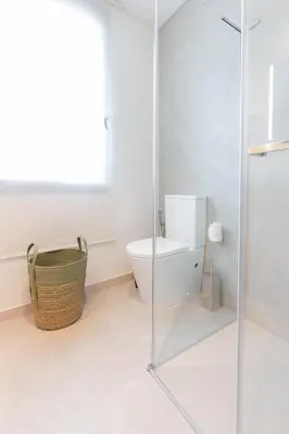 a bathroom with a toilet and a glass shower at Tulip Apartments Funchal by Mercado dos Lavradores com AC in Funchal