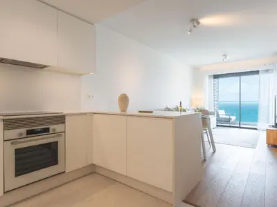 a kitchen with white cabinets and a view of the ocean at Glamorous Apartment by Atlantic Holiday in Funchal