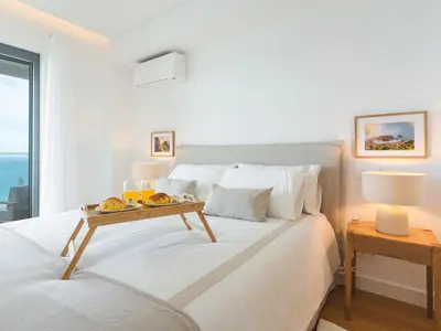 a bedroom with a bed with a tray of fruit on it at Glamorous Apartment by Atlantic Holiday in Funchal