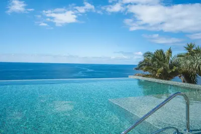 a swimming pool with a view of the ocean at Glamorous Apartment by Atlantic Holiday in Funchal