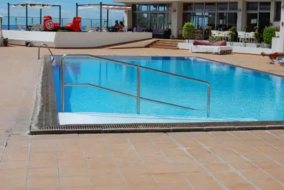 a large swimming pool with aicrobialicrobialicrobialicrobialicrobialicrobialicrobial at Apartamento do Mar in Funchal