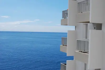 a view of the ocean from a building at Apartamento do Mar in Funchal