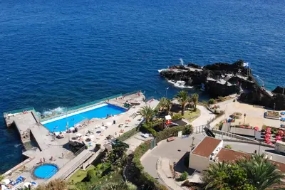 an aerial view of a resort next to the ocean at Apartamento do Mar in Funchal