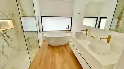 a white bathroom with two sinks and a mirror at Villa Nóbrega in Câmara de Lobos