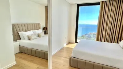 a bedroom with a bed and a large window at Villa Nóbrega in Câmara de Lobos