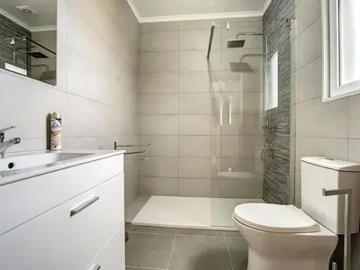 a bathroom with a shower and a toilet and a sink at Zen House By The Madeira Luxury Collection in Arco da Calheta