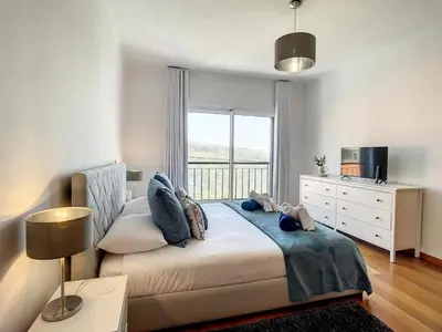 a bedroom with a bed and a large window at Zen House By The Madeira Luxury Collection in Arco da Calheta