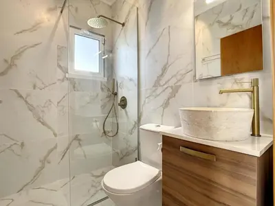 a bathroom with a toilet and a sink at Zen House By The Madeira Luxury Collection in Arco da Calheta