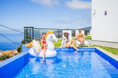 a group of people sitting on an inflatable pool at Zen House By The Madeira Luxury Collection in Arco da Calheta