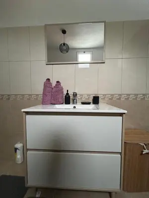 a bathroom with a white sink and a mirror at Celina Residence in Ribeira Brava