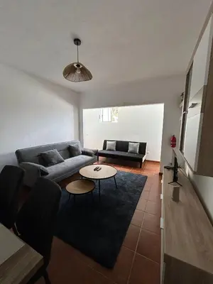 a living room with a couch and a table at Celina Residence in Ribeira Brava