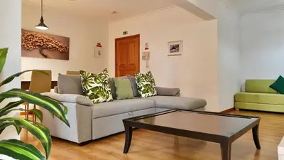 a living room with a couch and a coffee table at Green Haven in Funchal