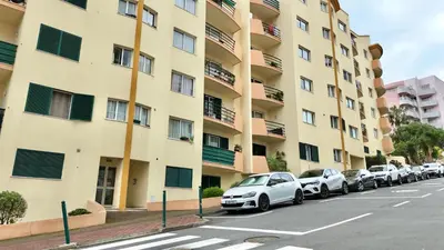 a row of cars parked in front of a building at Green Haven in Funchal