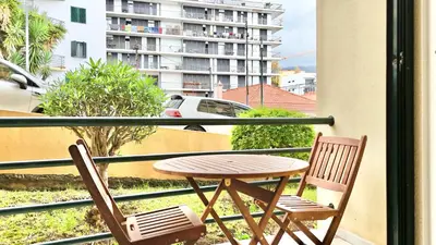 a table and two chairs on a balcony at Green Haven in Funchal
