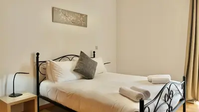 a bedroom with a bed with white sheets and pillows at Green Haven in Funchal