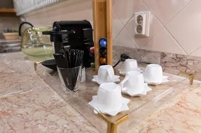 a counter with white cups and utensils on it at Suite 106 in Funchal