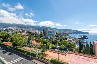 a view of a city with the ocean and buildings at Suite 106 in Funchal