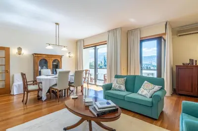 a living room with a green couch and a table at Suite 106 in Funchal