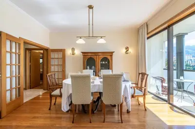 a dining room with a table and chairs at Suite 106 in Funchal