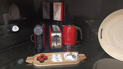 a counter top with a coffee maker and other items at Oudinot Residence by Mercado dos Lavradores com AC in Funchal