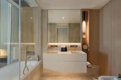 a bathroom with a tub and a sink and a mirror at Savoy Monumentalis I by An Island Apart in Funchal