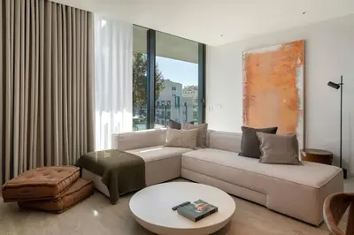 a living room with a couch and a table at Savoy Monumentalis I by An Island Apart in Funchal