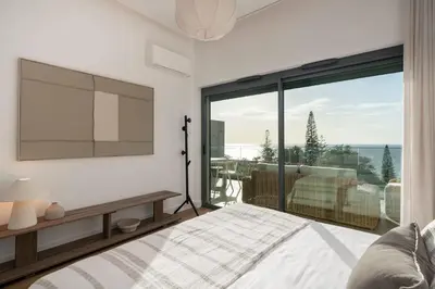 a bedroom with a bed and a large window at Acqua Residence II by An Island Apart in Funchal
