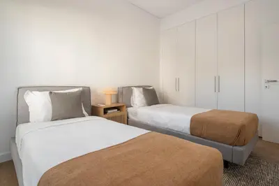 two beds in a small room with white walls at Acqua Residence II by An Island Apart in Funchal