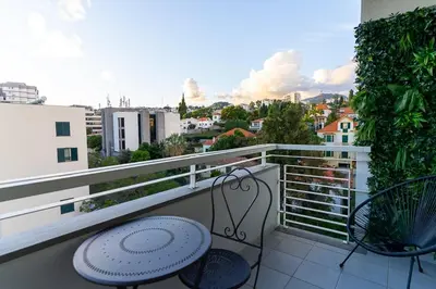 a balcony with a table and chairs and a view at GuestReady - Charming retreat in Funchal in Funchal