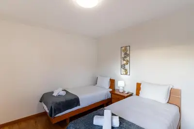 two beds in a room with crosses on the floor at GuestReady - Charming retreat in Funchal in Funchal