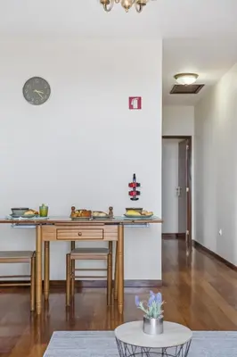 a kitchen with a wooden table and a dining room at Horizon Glow II by Zest & Guest in Ponta do Pargo