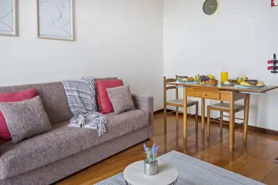 a living room with a couch and a table at Horizon Glow II by Zest & Guest in Ponta do Pargo