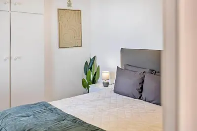 a bedroom with a bed with purple pillows at SUPER Sunset in Ponta Delgada