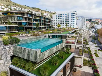 an apartment complex with a swimming pool and buildings at Savoy Residence Monumentalis VA by LM&AC Signature in Funchal