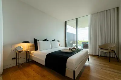 a hotel room with a bed and a large window at Savoy Residence Monumentalis VA by LM&AC Signature in Funchal