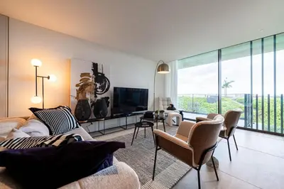a living room with a couch and a tv at Savoy Residence Monumentalis VA by LM&AC Signature in Funchal
