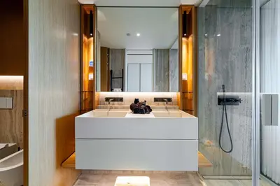 a bathroom with a large mirror and a shower at Savoy Residence Monumentalis VA by LM&AC Signature in Funchal