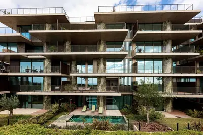 an apartment building with a pool in front of it at Savoy Residence Monumentalis VA by LM&AC Signature in Funchal