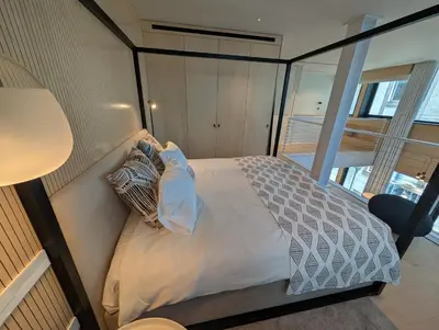 a bedroom with a bed in a room with a window at Savoy Residence City Loft - Style and Sophistication in Funchal