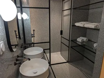 a bathroom with two toilets and a glass shower at Savoy Residence City Loft - Style and Sophistication in Funchal