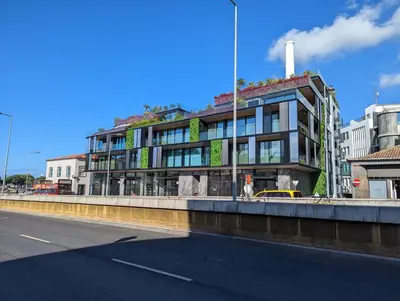 a building on a city street next to a road at Savoy Residence City Loft - Style and Sophistication in Funchal
